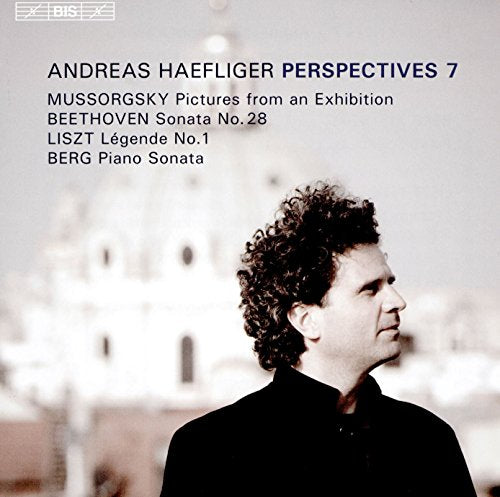 "CD cover with a man in a black suit and curly hair."