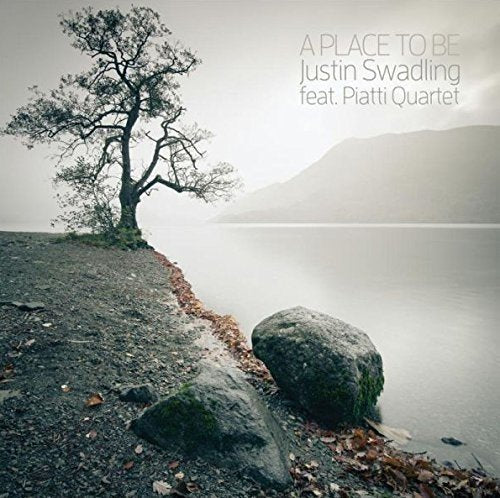 Album cover: lakeside landscape with a lone tree, muted tones.