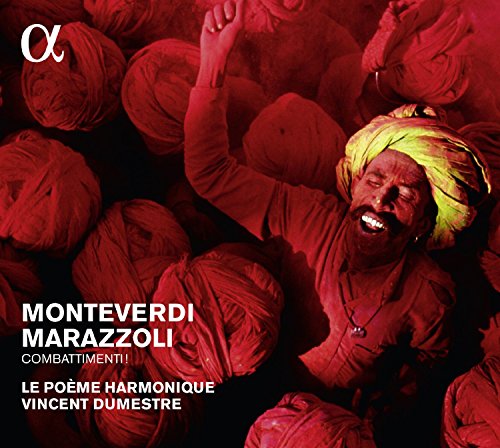 Man in yellow turban surrounded by red-toned figures, raising hand, on a CD cover.