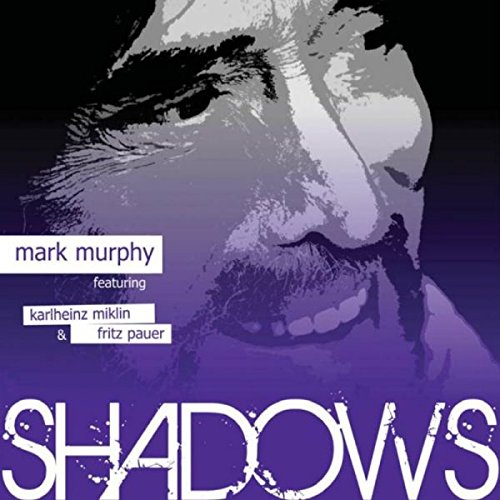"Album cover with a man's face in shades of gray and purple tones."