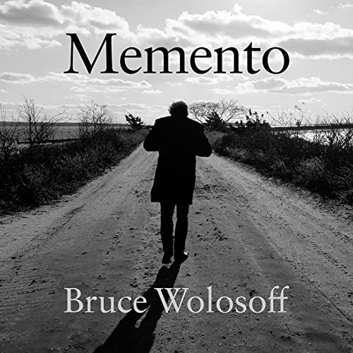 Black and white album cover featuring a man walking down a road.