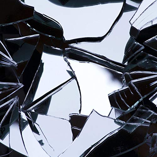 Shattered glass fragments against a dark, reflective background.