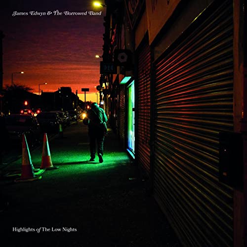 Album cover: a lone figure walks down a dimly lit street at dusk.