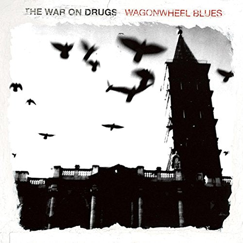 Black and white album cover with birds flying near a tower.