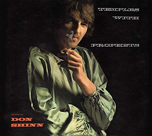 "Album cover featuring a man in a green robe holding a flower."