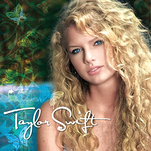 The image displays the cover of Taylor Swift's self-titled debut album. It features a young Taylor Swift with curly blonde hair, prominently positioned against a colorful background that includes floral elements and a butterfly.