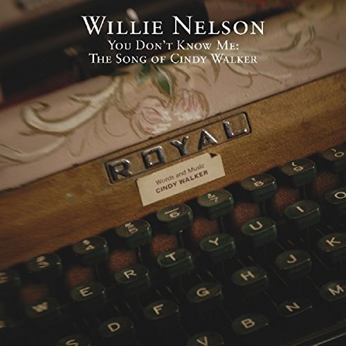 "Vintage Royal typewriter with floral design, black keys, and 'Cindy Walker' engraved plate."
