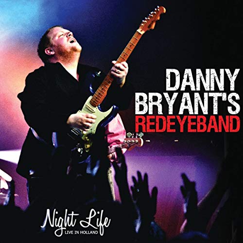 Danny Bryant playing guitar onstage with raised hands in the crowd.