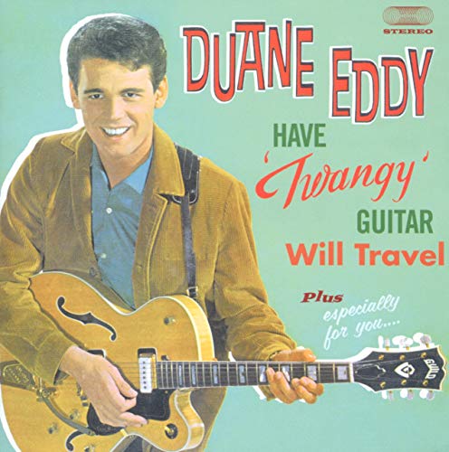 Duane Eddy smiling while holding a hollow-body electric guitar on a light green background.