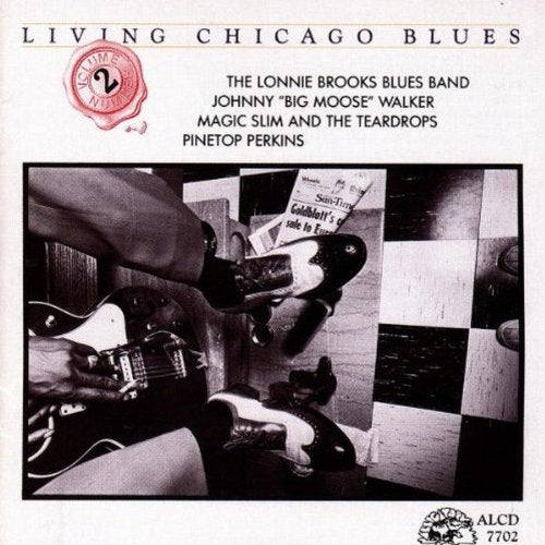 "CD cover with black and white image of musicians playing guitars."