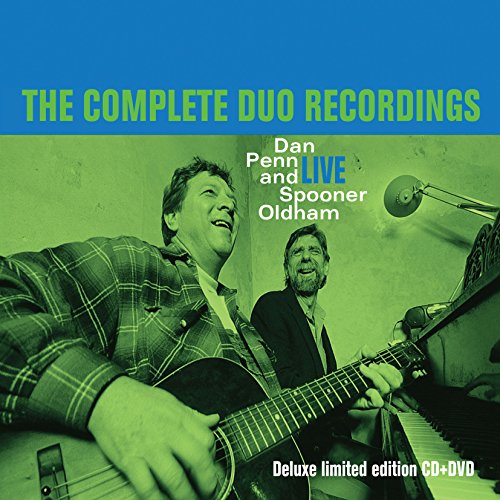 Album cover with two men, one playing guitar, on green and blue background.