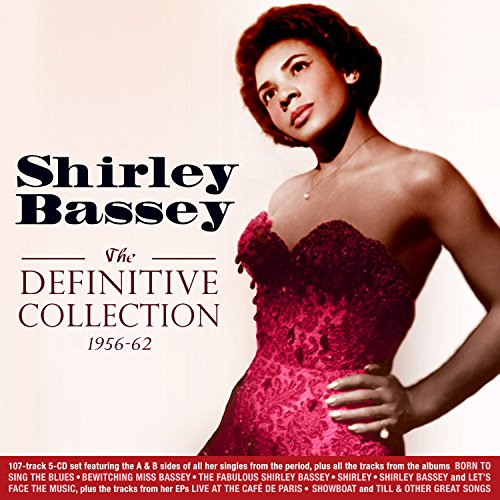 "CD cover featuring Shirley Bassey in a red dress, posing confidently."