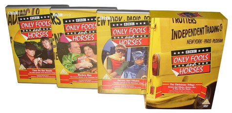 "Four yellow DVD cases for 'Only Fools and Horses' Christmas episodes on a white background."