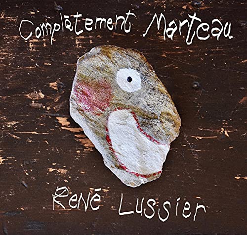 CD cover: painted rock resembling an animal face on woodgrain.