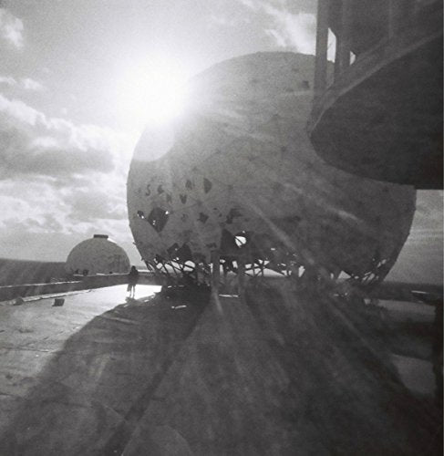 A black-and-white image of a vinyl record with a large, damaged record.