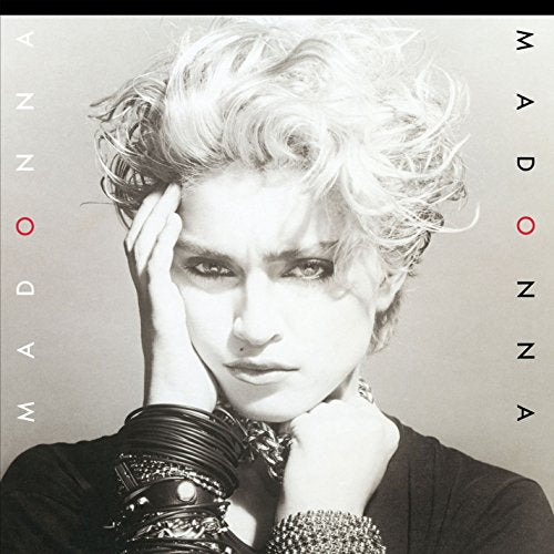 Black and white portrait of Madonna with her name written vertically on both sides.