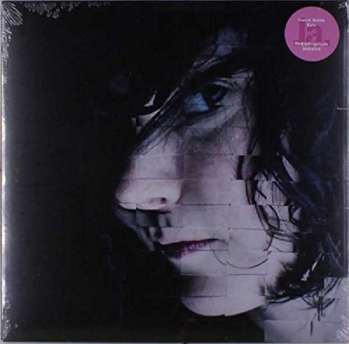 "Vinyl album cover featuring a close-up of a woman's face with blue eyes."