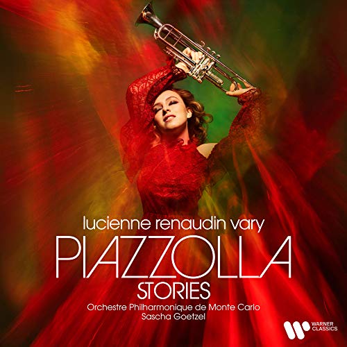 "Woman in red dress holding trumpet aloft against red and green background."