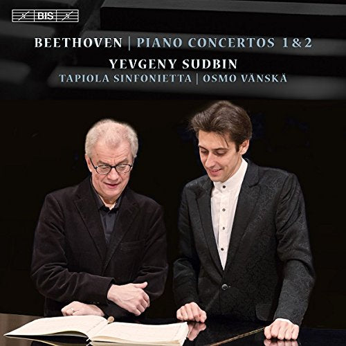 CD cover featuring two men in suits, one holding a baton, against a black background.