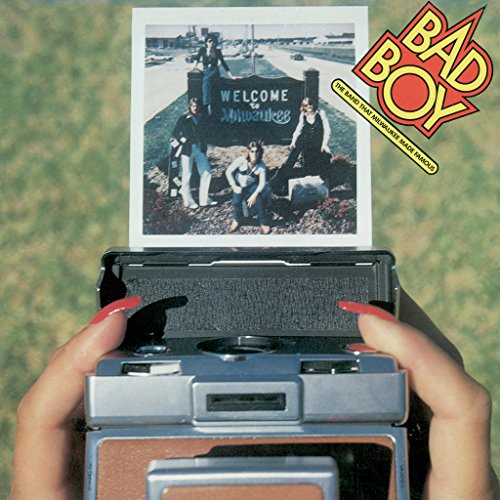 CD cover featuring a band posed in front of a "Welcome to Milwaukee" sign.