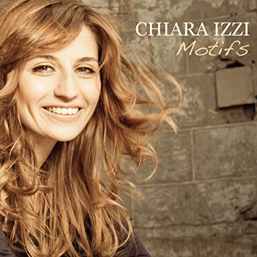 Album cover featuring a smiling woman with long, wavy hair against a stone wall.