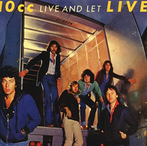 10cc band members posing near the open door of a transport truck.