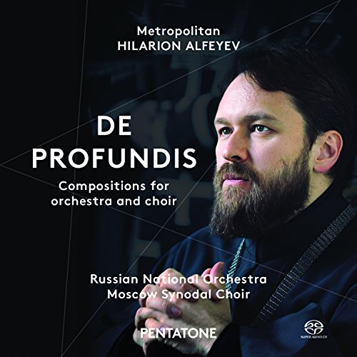 "CD cover featuring a bearded man in dark attire against a black background."