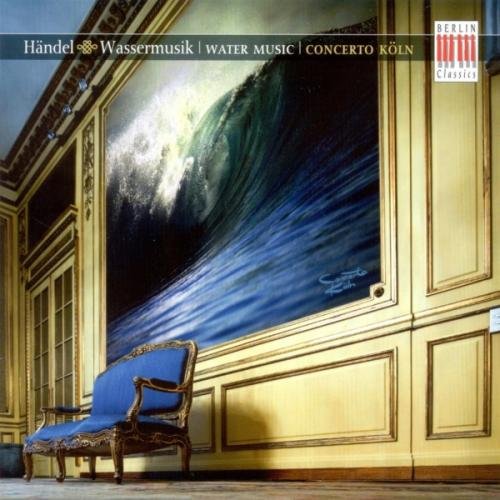 A blue chair sits in a room with a large wave painting.