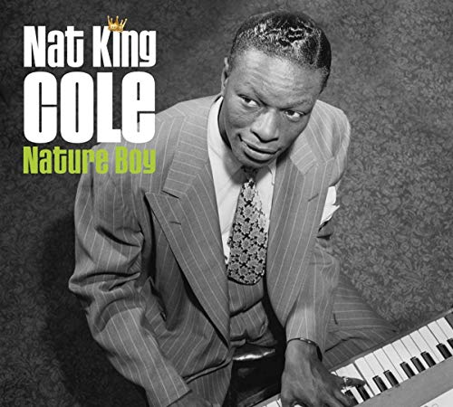 Nat King Cole album cover with man in suit playing piano, black and white image.