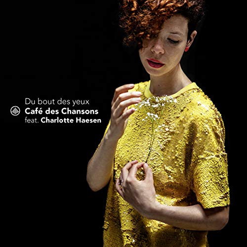 A woman in a yellow dress against a black background, CD cover art.