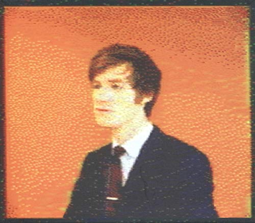 Portrait of a man in a suit with a textured, orange background.