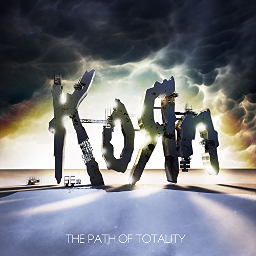 The image depicts the album cover for Korn's "The Path of Totality". Alt text: Metallic "KORN" sculpture with lights, under a cloudy sky.