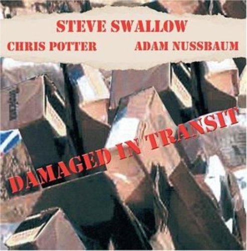 "Album cover with damaged cardboard boxes and red text on beige banner."