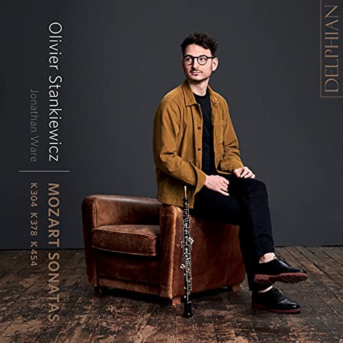 Man with violin on brown chair, album cover for Mozart sonatas.