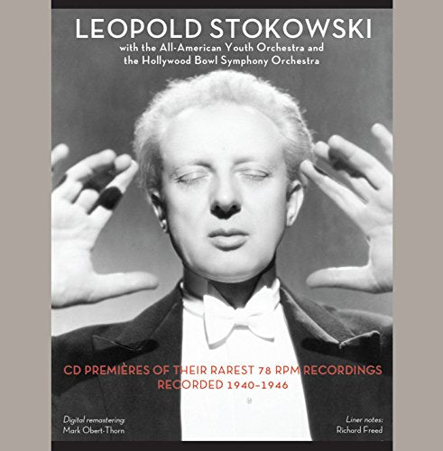 Black and white portrait of conductor Leopold Stokowski with orchestra details.