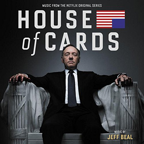 "CD cover featuring a man in a suit with bloody hands on a chair."