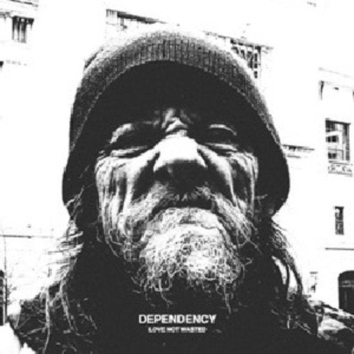 Black and white close-up of a bearded man wearing a knit cap.
