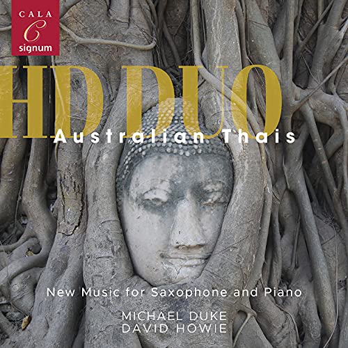 CD cover featuring a stone Buddha head amongst tree roots.