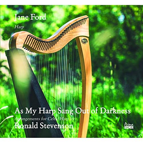 "CD cover featuring a wooden harp in a green, outdoor setting."