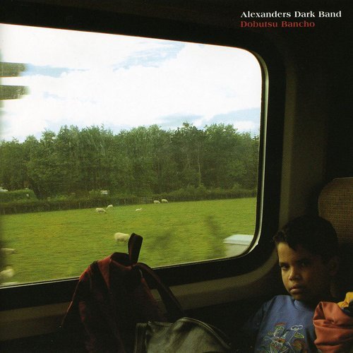 "Album cover with a child on a train, looking out at a green field."