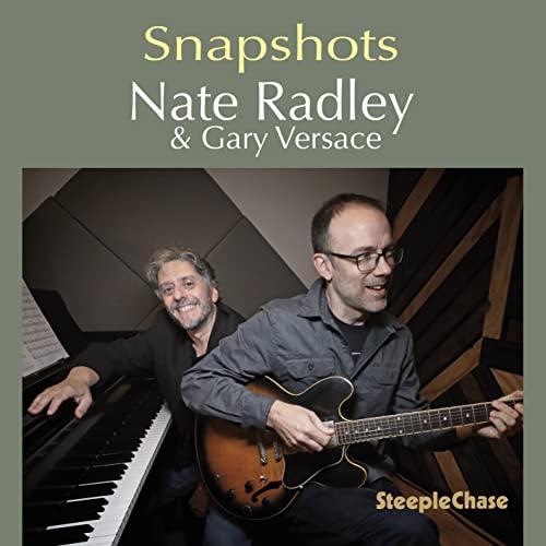 CD cover featuring two smiling musicians with a guitar and piano.