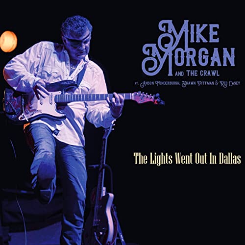 Musician playing electric guitar on album cover, "The Lights Went Out In Dallas".