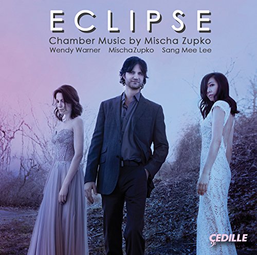 Album cover: "Eclipse" with three musicians in formal attire against a misty, bare landscape.