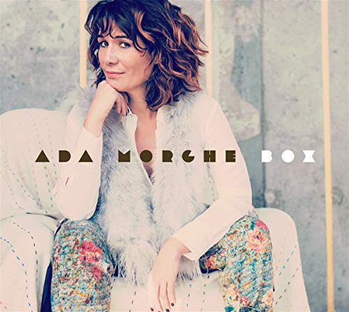 Album cover featuring a woman sitting on a white couch, wearing floral pants.