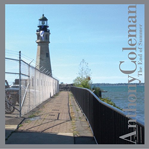 "Album cover with a man on a lighthouse and a fenced walkway."