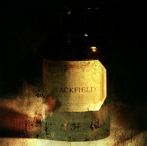 A vinyl record sleeve featuring a bottle with a "BLACKFIELD" label, textured background.