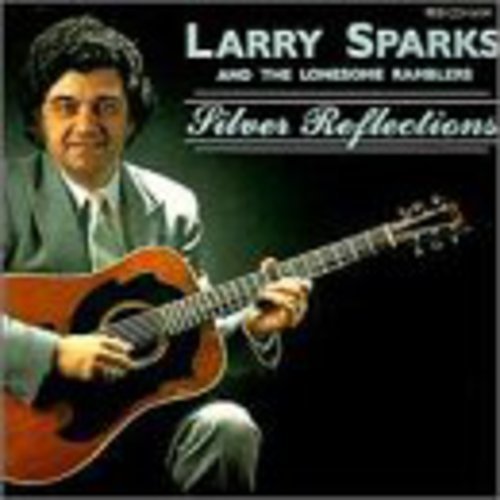 Man in suit holding guitar, album cover with title "Silver Reflections" and artist name.