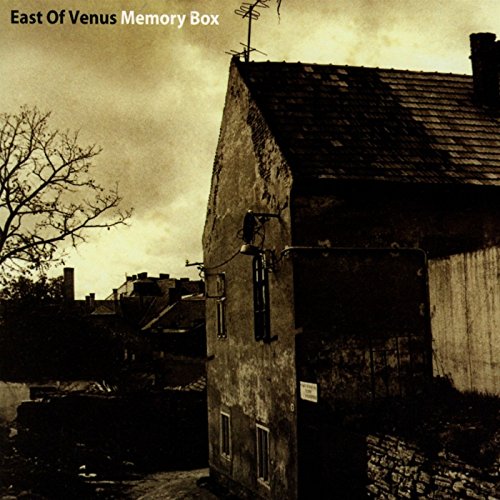 "Album cover featuring a sepia-toned image of a weathered stone building and rooftops."
