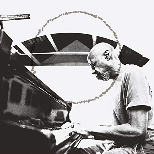 Black and white album cover featuring a man playing a piano.