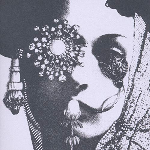 Black and white close-up of a person with ornate jewelry.